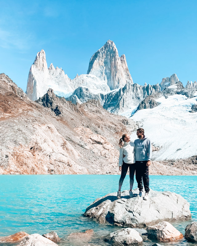 A couple stands in front of mount Fitz Roy, El Chalten, Argentina