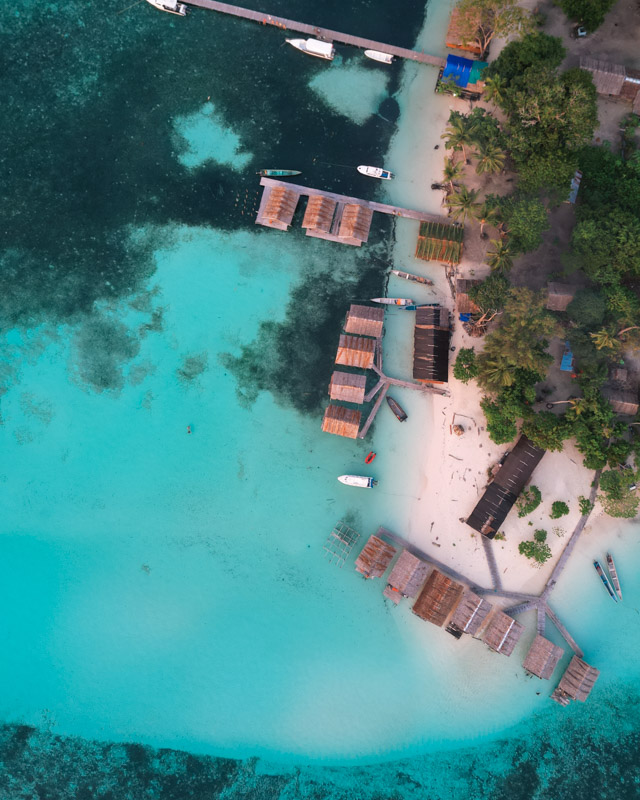 Drone shot of overwater bungalows in Raja Ampat, Indonesia