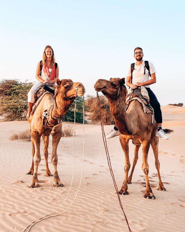 A couple sits on camel, near Jaisalmer, That desert, Rajasthan, India